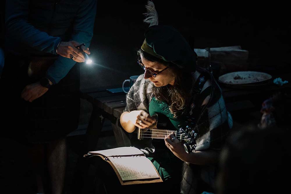 Sarah serenades everyone at the campfire